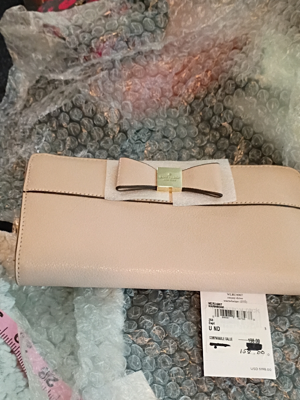kate spade pale pink bow clutch with gold-tone plaque
